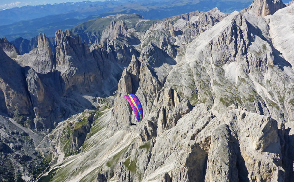 Paragliding above Dolomites, Catinaccio Massif near Sella Pass and Col Rodella, Italian Alps