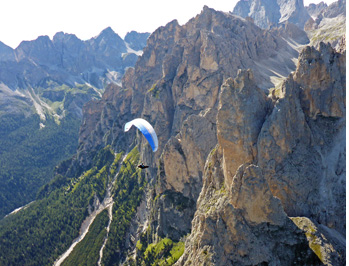 Paragliding the Dolomites. Limestone towers of the Rosengarten group - the first turn point of the classic Dolomites aerial tour from Col Rodella takeoff.