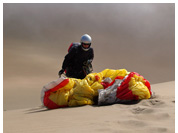 Paraglider take-off at mountain dunes of Camanchaca Dunes, Iquique, Atacama Desert, Chile 