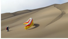 Kiting up a paraglider to the take-off at inland mountain dunes - Barefoot Dunes, Iquique, Atacama Desert, Chile 